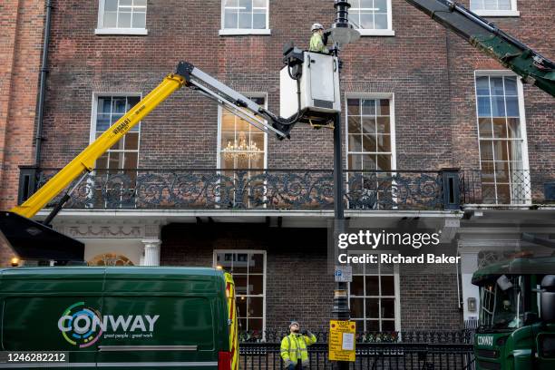 Street lighting technicians with the contractor, Conway, change street lighting to new LED bulbs above the streets of Mayfair, on 16th January 2023,...