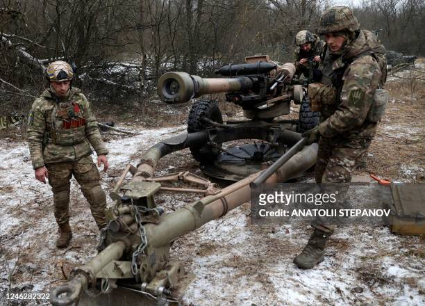 Ukrainian artillerymen prepare to fire an L119 howitzer towards Russian positions at a front line in the Lugansk region on January 16 amid the...