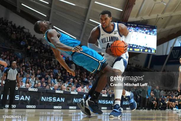 Eric Dixon of the Villanova Wildcats fouls Bryson Mozone of the Georgetown Hoyas in the second half at Finneran Pavilion on January 16, 2023 in...