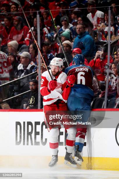 Michael Rasmussen of the Detroit Red Wings collides with Erik Johnson of the Colorado Avalanche at Ball Arena on January 16, 2023 in Denver, Colorado.