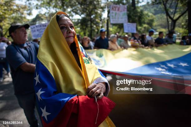 Woman wears a Venezuelan flag during a protest in Caracas, Venezuela, on Monday, Jan. 16, 2023. Hundreds of public school teachers marched in...