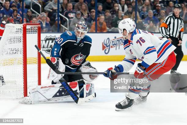 Elvis Merzlikins of the Columbus Blue Jackets stops a shot from Jonny Brodzinski of the New York Rangers during the first period of the game at...