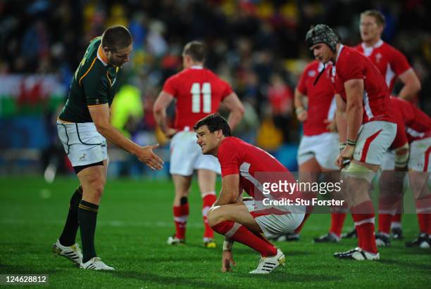 Dejected Wales scrumhalf Mike Phillips is offered a handshake by Francois Steyn of South Africa following the final whistle during the IRB 2011 Rugby...