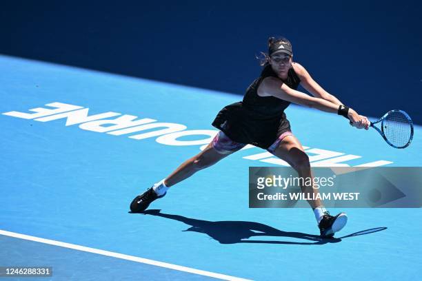 Spain's Garbine Muguruza hits a return against Belgium's Elise Mertens during their women's singles match on day two of the Australian Open tennis...