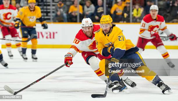 Ryan McDonagh of the Nashville Predators skates against Jonathan Huberdeau of the Calgary Flames during an NHL game at Bridgestone Arena on January...