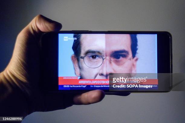 In this photo illustration, a smartphone screen with live news from an Italian television channel about the arrest of fugitive Matteo Messina Denaro....