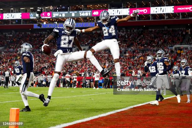 Jayron Kearse of the Dallas Cowboys celebrates with Israel Mukuamu after intercepting a pass during the second quarter of an NFL wild card playoff...