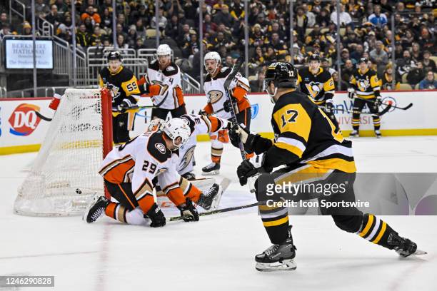 Pittsburgh Penguins Right Wing Bryan Rust scores the game-tying goal against Anaheim Ducks Goalie John Gibson during the third period in the NHL game...
