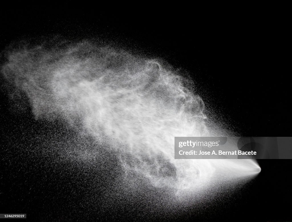 Full frame of the textures formed by the water jets to pressure with drops floating in the air of color white on a black background