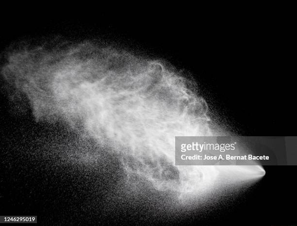 full frame of the textures formed  by the water jets to pressure with drops floating in the air of color white on a black background - spray stock pictures, royalty-free photos & images