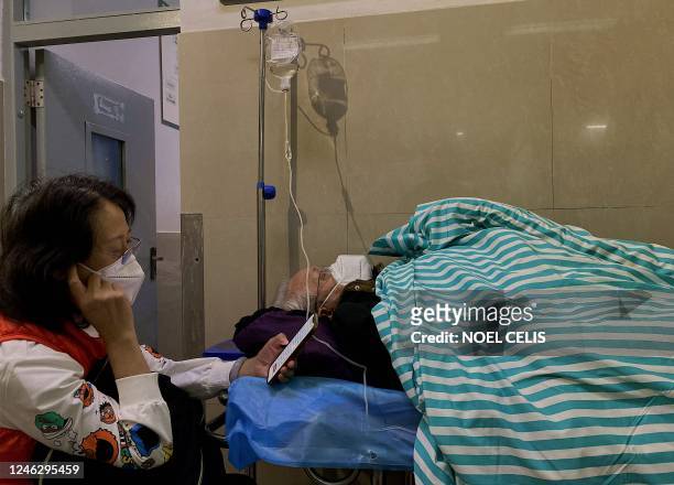 This photo taken on January 9 shows a patient with Covid-19 coronavirus at a hospital in Jinghong City, at Xishuangbanna Dai Autonomous Prefecture,...