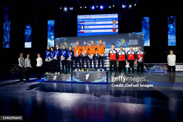 Teams of Italy, Netherlands and Poland seen on a podium during the ISU European Short Track Speed Skating Championships at Hala Olivia Arena on...