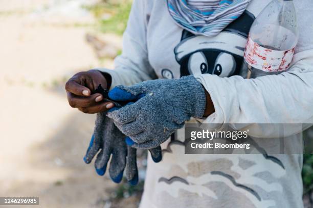 Local clean-up worker who sifts through beach sand to collect plastics and nurdles washed ashore from a sunken container ship in Uswetakeiyawa, Sri...