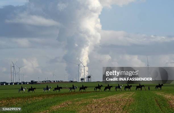 Mounted policemen build a cordon to prevent environmentalists from advancing to Luetzerath during a demonstration in Keyenberg, western Germany, as...