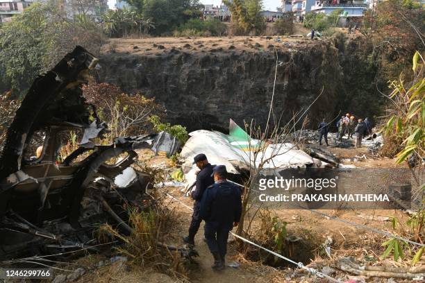 Rescue teams search for victims at the site of the Yeti Airlines plane crash, in Pokhara on January 17, 2023. - The Yeti Airlines flight with 68...