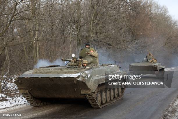 Ukrainian soldiers ride in an armoured personnel carrier along a road not far from Bakhmut, Donetsk region on January 17, 2023.