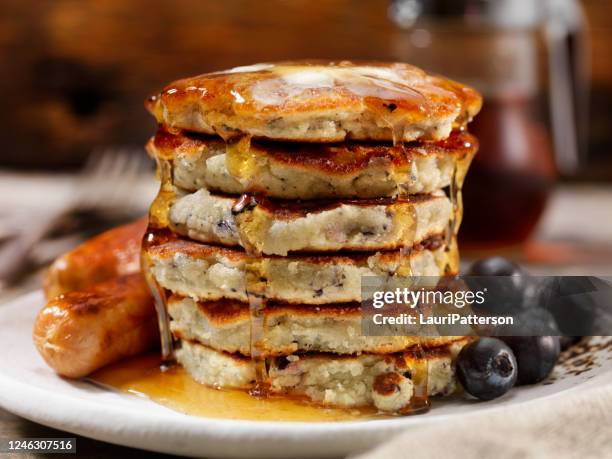 mini blueberry pancakes with maple syrup and sausages - blueberry pancakes stock pictures, royalty-free photos & images