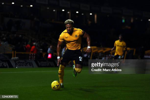 Adama Traore of Wolverhampton Wanderers dribbles the ball as the stadium floodlights briefly fail early in the game during the Emirates FA Cup Third...