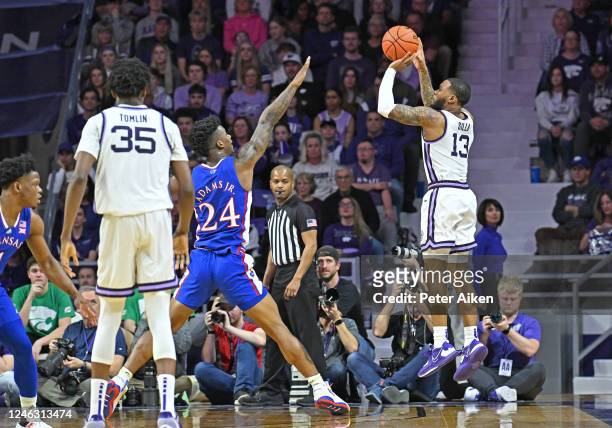 Desi Sills of the Kansas State Wildcats hits a three point shot against K.J. Adams Jr. #24 of the Kansas Jayhawks, in the first half at Bramlage...