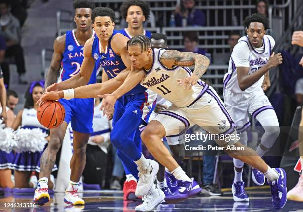 Keyontae Johnson of the Kansas State Wildcats reaches in for the ball against Kevin McCullar Jr. #15 of the Kansas Jayhawks in the first half at...