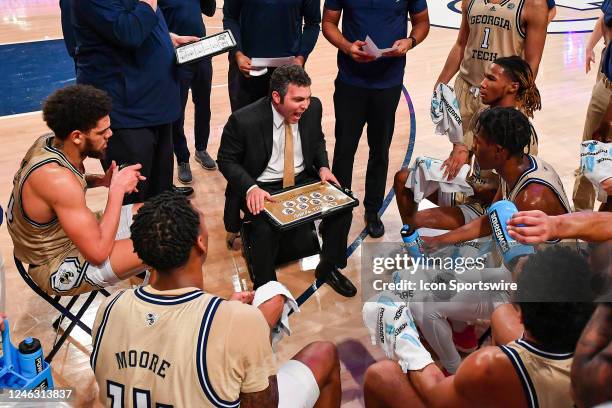 Georgia Tech head coach Josh Pastner talks to his players in the huddle during a college basketball game between the North Carolina State Wolfpack...