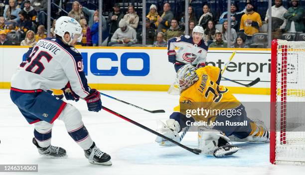 Kevin Lankinen of the Nashville Predators makes the save against Jack Roslovic of the Columbus Blue Jackets during an NHL game at Bridgestone Arena...