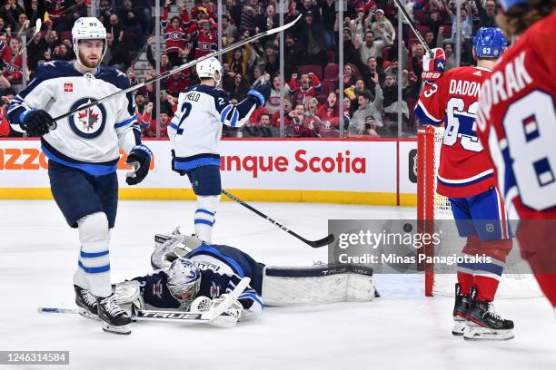 Goaltender Connor Hellebuyck of the Winnipeg Jets lies on the ice after a goal by Evgenii Dadonov of the Montreal Canadiens during the second period...