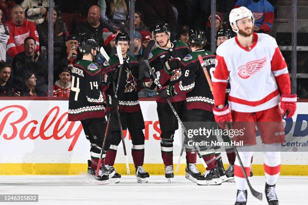 Nick Bjugstad of the Arizona Coyotes celebrates with Dylan Guenther, Jakob Chychrun and teammates after scoring a goal during the second period...