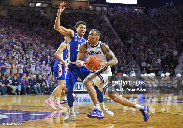 Keyontae Johnson of the Kansas State Wildcats drives to the basket against Kevin McCullar Jr. #15 of the Kansas Jayhawks, in the second half at...