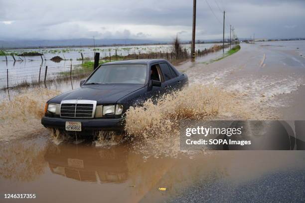 The road flooded in Gilroy and a car drove on the flooding area. Powerful storm systems have slammed California since December 2022, with thousands...