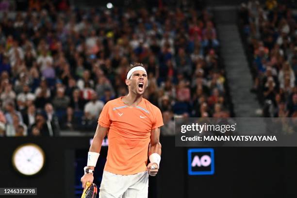 Spain's Rafael Nadal reacts as he plays against USA's Mackenzie McDonald during their men's singles match on day three of the Australian Open tennis...