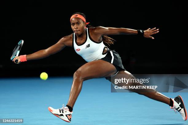 Coco Gauff of the US hits a return against Britain's Emma Raducanu during their women's singles match on day three of the Australian Open tennis...