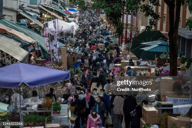 General view showing people buying flowers at a flowers market on January 18, 2023 in Hong Kong, China. Chinese New Year or Lunar New Years Holiday...