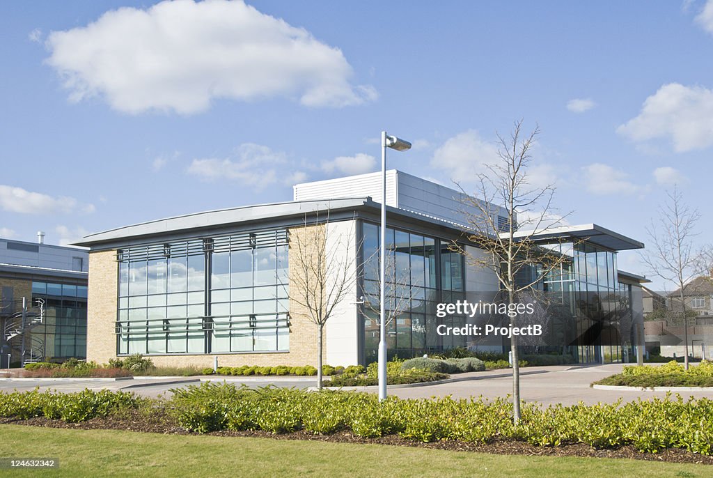 A distance shot of a glass walled office building