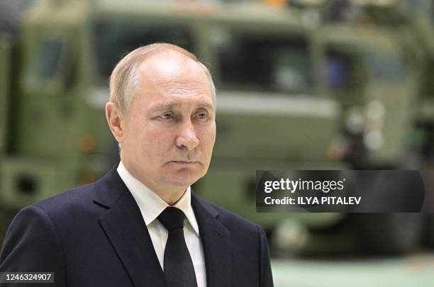 Russian President Vladimir Putin meets with workers at a plant, which is part of Russian missile manufacturer Almaz-Antey, in Saint Petersburg on...