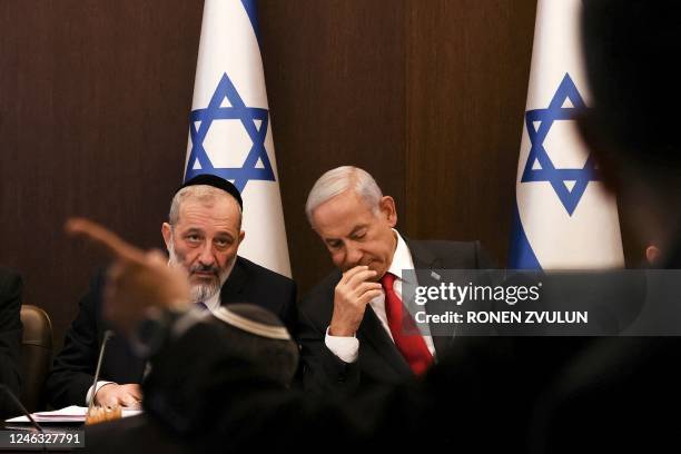 Israel's Prime Minister Benjamin Netanyahu sits next to Interior and Health Minister Aryeh Deri during a weekly cabinet meeting at the Prime...