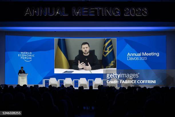 Ukrainian President Volodymyr Zelensky is displayed on a screen via video link at the Congress centre during the World Economic Forum annual meeting...