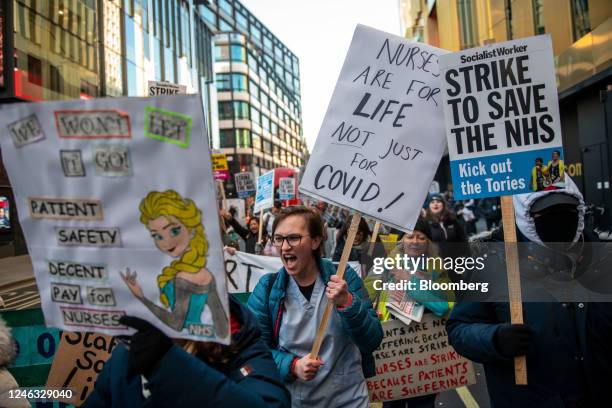 Nurses hold placards and chant on a march through central London to Downing Street during a strike action by the Royal College of Nursing in London,...