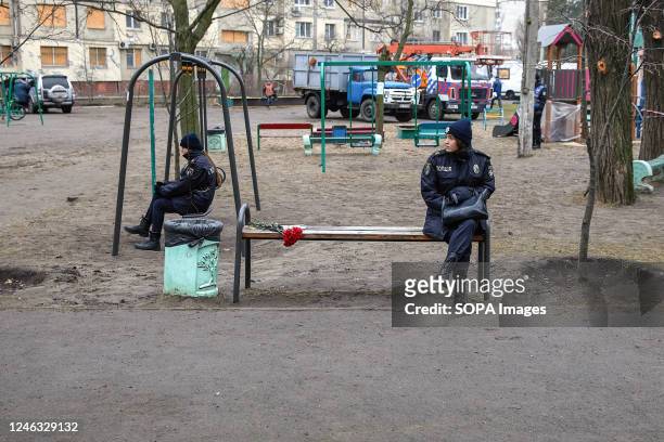 Two policewomen watch from the playground the building destroyed by a Russian missile in the city of Dnipro. Four days after a Russian Kh-22 missile...