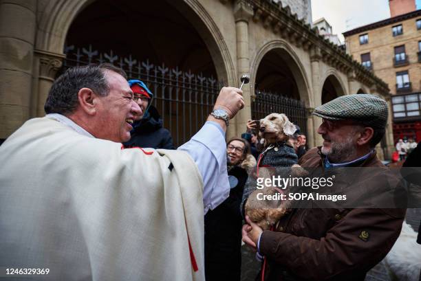 Pet is blessed by the parish priest Cesar Magaña outside the Church of San Nicolás in Pamplona to celebrate the day of San Antón, the patron saint of...
