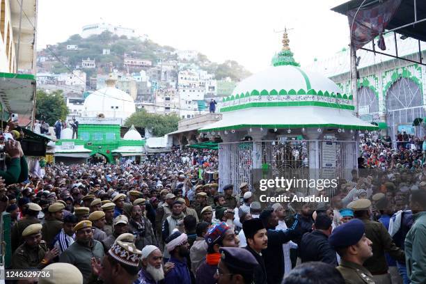 Indian Muslim devotees take part in the Flag hoisting ceremony during religious procession for the annual Urs festival at the shrine of Sufi saint...
