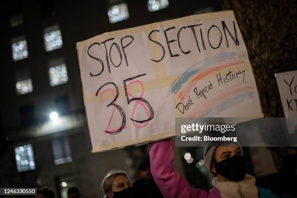 Protester holds a placard that reads "Stop Section 35 Don't Repeat History" during a protest, over the use of Section 35 of the 1998 Scotland Act,...