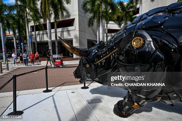 People walk past the Crypto Bull installed across the James Lawrence King Federal Justice Building, where the court proceeding of Anatoly Legkodymov,...