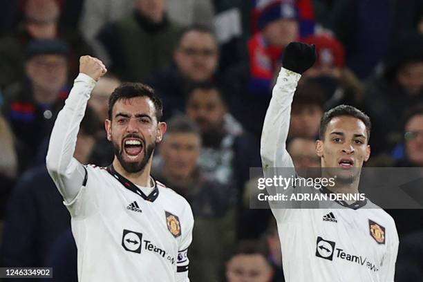 Manchester United's Portuguese midfielder Bruno Fernandes celebrates with teammates after scoring his team first goal during the English Premier...