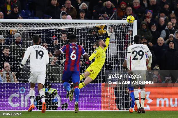 Crystal Palace's French midfielder Michael Olise shoots a penalty kick and scores his team first goal past Manchester United's Spanish goalkeeper...