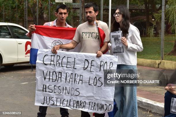 People hold a poster that reads "Lifetime sentence for the murderers, justice for Fernando" during a protest hold by law students to support the...