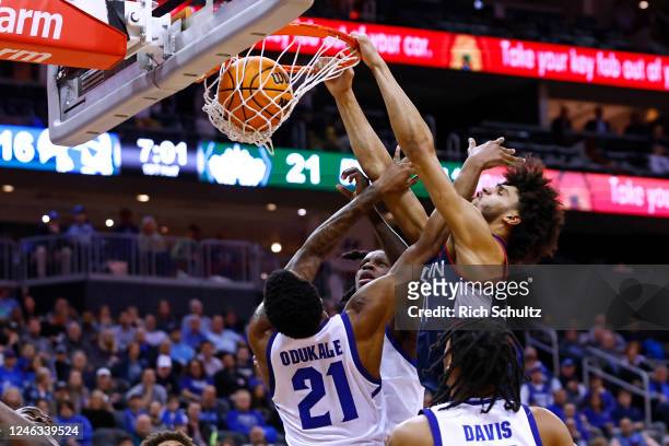 Andre Jackson Jr. #44 of the Connecticut Huskies dunks as Femi Odukale Kadary Richmond and Dre Davis of the Seton Hall Pirates defends during the...