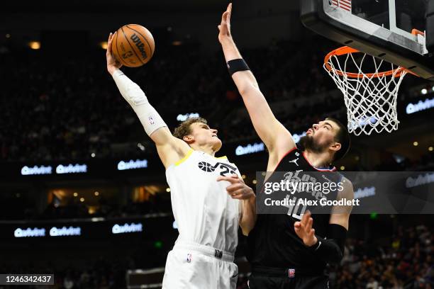 Lauri Markkanen of the Utah Jazz dunks over Ivica Zubac of the LA Clippers during the second half of a game at Vivint Arena on January 18, 2023 in...