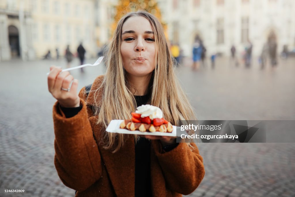 Woman eating belgium waffles