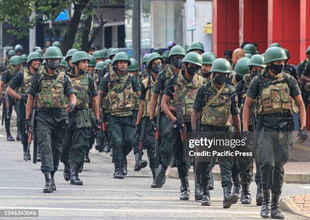 Armed Sri Lankan army soldiers patrol during a protest march against the government's crackdown and the current economic crisis.